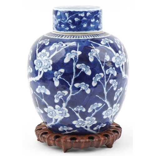 1257 - Large Chinese prunus pattern ginger jar and cover on carved wooden stand, 33cm high