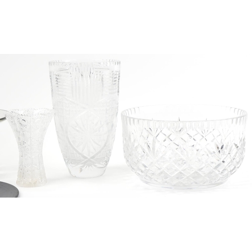 2309 - Large cut glass fruit bowl, vase, black glass posy ring, glass bowl and thistle cut vase, the larges... 