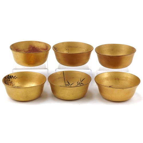 1113 - Set of six Japanese gilt lacquered rice bowls decorated with flowers and fish, each 12cm in diameter