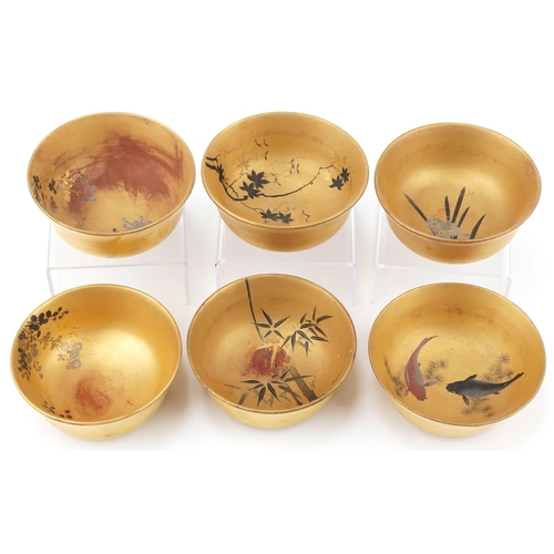 1113 - Set of six Japanese gilt lacquered rice bowls decorated with flowers and fish, each 12cm in diameter