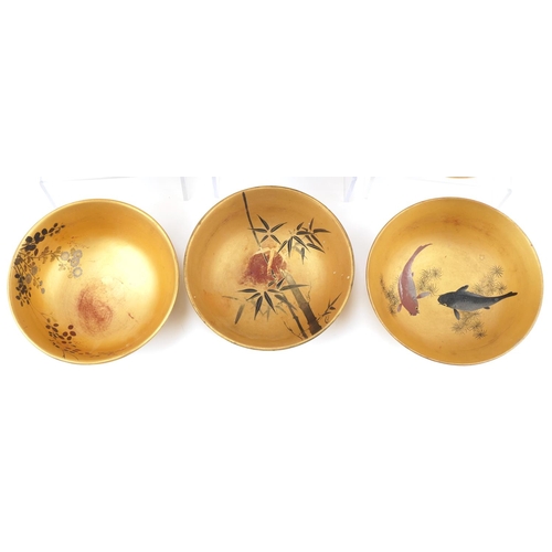 1113 - Set of six Japanese gilt lacquered rice bowls decorated with flowers and fish, each 12cm in diameter