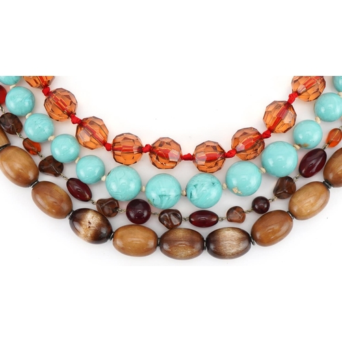 3563 - Four vintage bead necklaces including horn and amber coloured beads