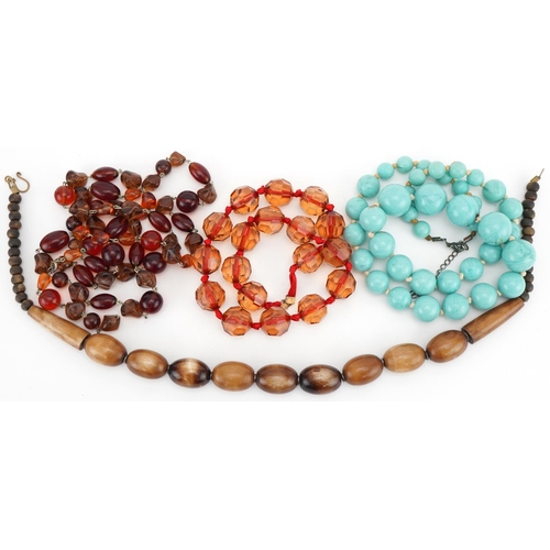 3563 - Four vintage bead necklaces including horn and amber coloured beads