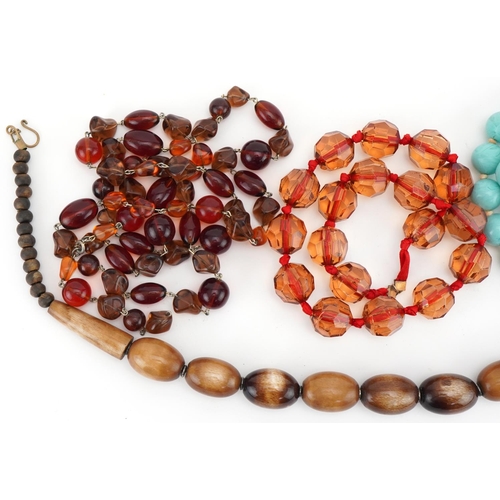 3563 - Four vintage bead necklaces including horn and amber coloured beads