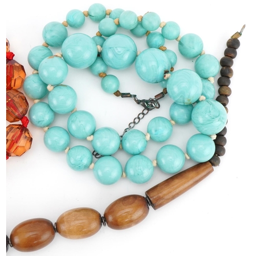 3563 - Four vintage bead necklaces including horn and amber coloured beads