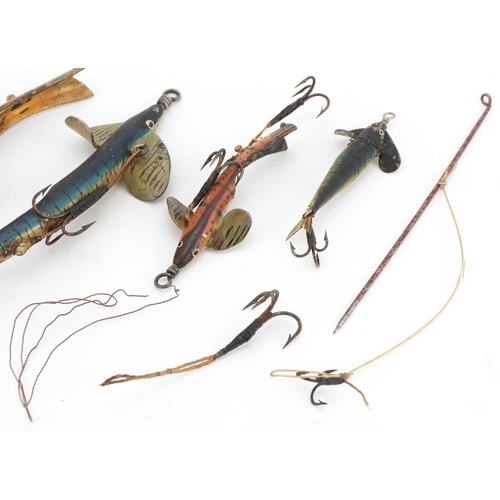 1410 - Four hand painted metal fishing lures, the largest 8cm in length