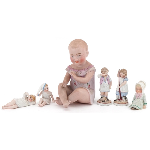 1159 - Six Victorian bisque figurines including a piano baby, the largest 16cm high