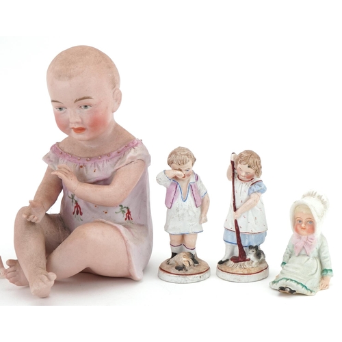 1159 - Six Victorian bisque figurines including a piano baby, the largest 16cm high