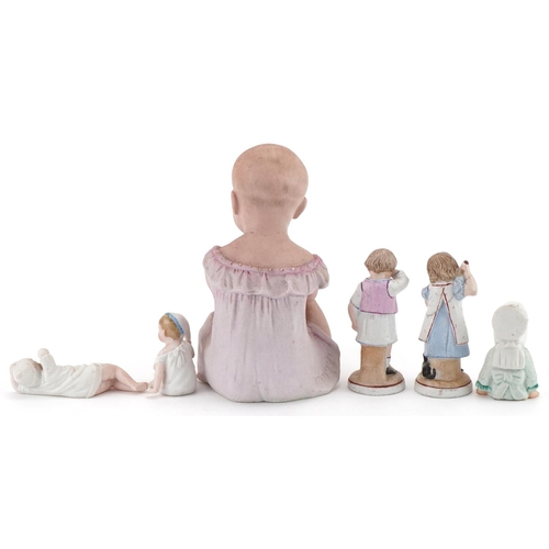 1159 - Six Victorian bisque figurines including a piano baby, the largest 16cm high