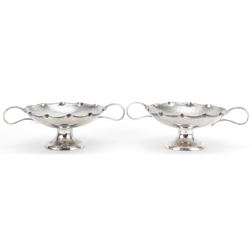 1021 - Wang Hing, pair of Chinese export silver sweetmeat dishes with twin handles, each 15.5cm wide, total... 