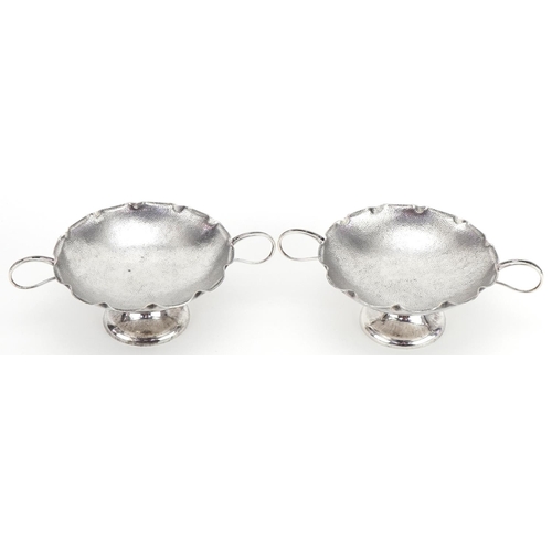 1021 - Wang Hing, pair of Chinese export silver sweetmeat dishes with twin handles, each 15.5cm wide, total... 