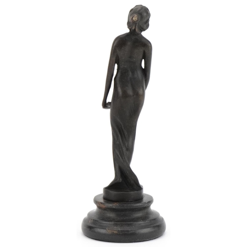 2217 - Patinated bronze figure of an Art Nouveau female holding a tray, raised on a black marble base, 19.5... 