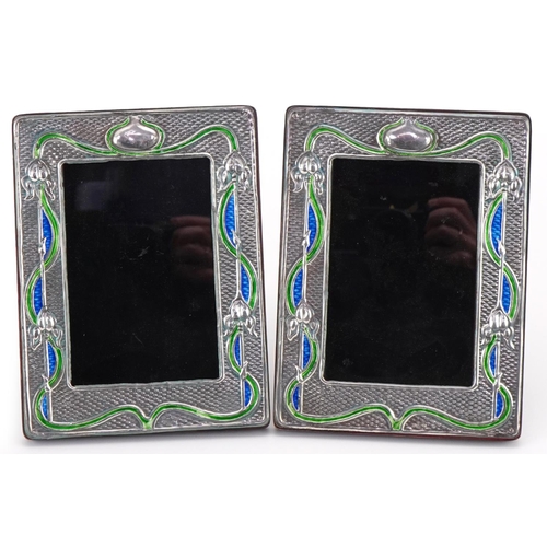 65 - Pair of Art Nouveau style sterling silver and enamel easel photo frames embossed with stylized flowe... 