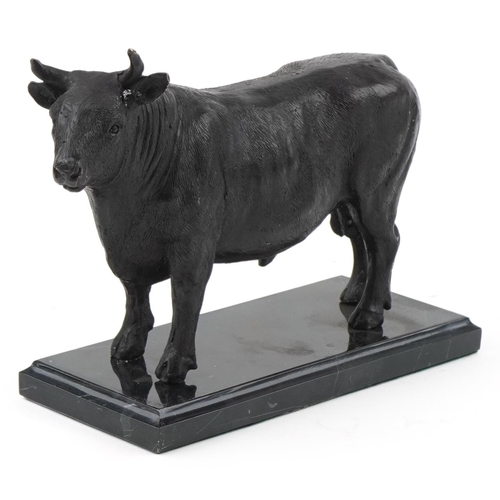 2292 - Patinated bronze study of a bull raised on a black marble base, 26cm in length