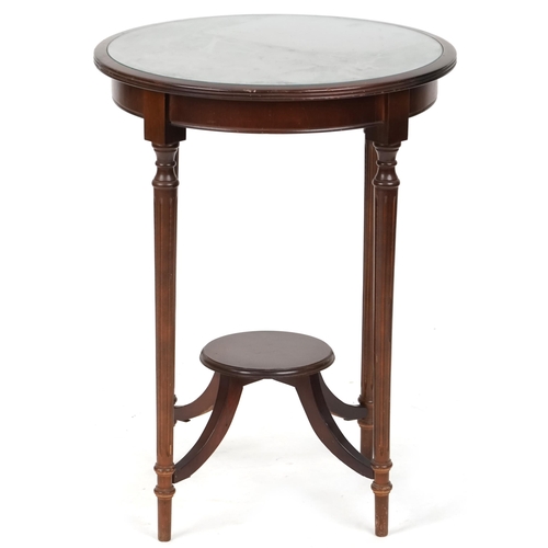 716 - Edwardian mahogany circular occasional table with under tier raised on reeded legs, 73cm high x 54cm... 