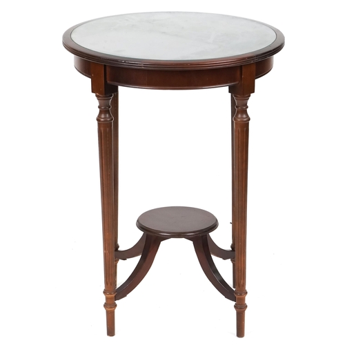 716 - Edwardian mahogany circular occasional table with under tier raised on reeded legs, 73cm high x 54cm... 