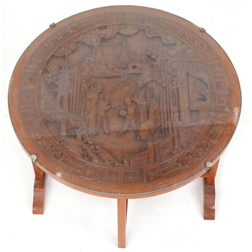 738 - Chinese hardwood folding occasional table, 20th century, carved with figures amongst pagodas, 52cm h... 