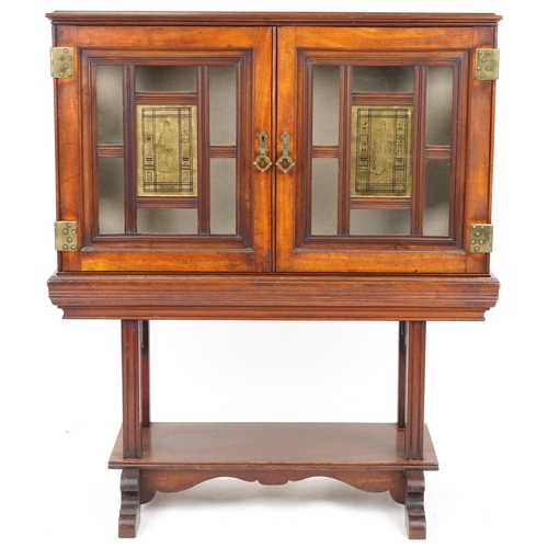 599 - Edwardian mahogany display cabinet on stand, the doors and sides each fitted with a brass panel depi... 