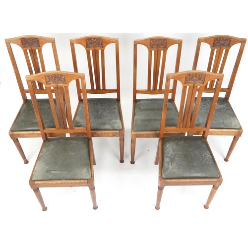 601 - Set of six early 20th century Arts & Crafts oak dining chairs with carved back rails above drop in s... 