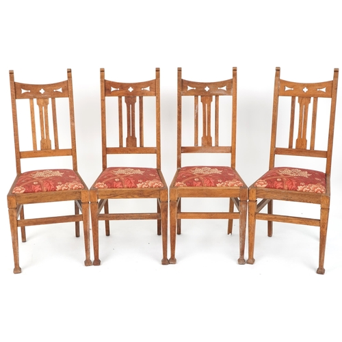 550 - Set of four early 20th century Arts & Crafts oak dining chairs with pierced decoration above drop in... 