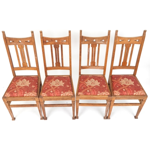 550 - Set of four early 20th century Arts & Crafts oak dining chairs with pierced decoration above drop in... 