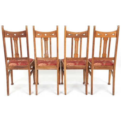 550 - Set of four early 20th century Arts & Crafts oak dining chairs with pierced decoration above drop in... 