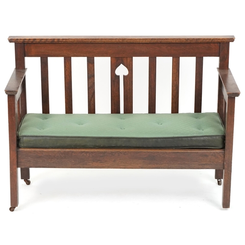 600 - Early 20th century Arts & Crafts oak two seat hall settle retailed by Liberty & Co, 80cm H x 112cm W... 