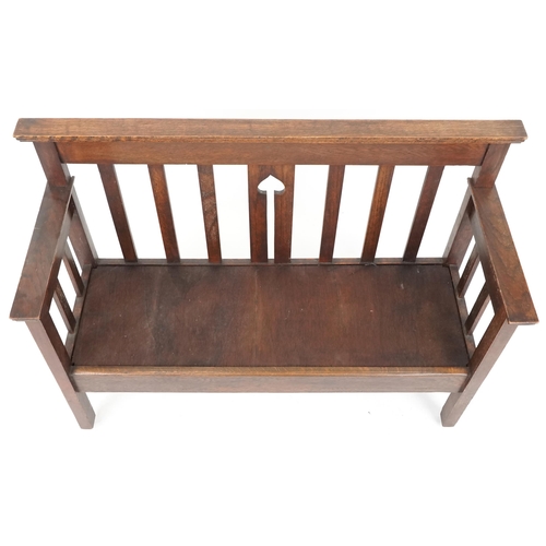 600 - Early 20th century Arts & Crafts oak two seat hall settle retailed by Liberty & Co, 80cm H x 112cm W... 