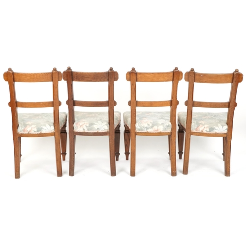 608 - Set of four early 20th century Gothic revival oak dining chairs with overstuffed seats, 91cm H x 47c... 