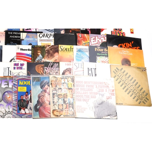 1500 - Vinyl LP records including Kool & The Gang, The Barron Knights, The Jukes, The Hollies, Paul Simon, ... 