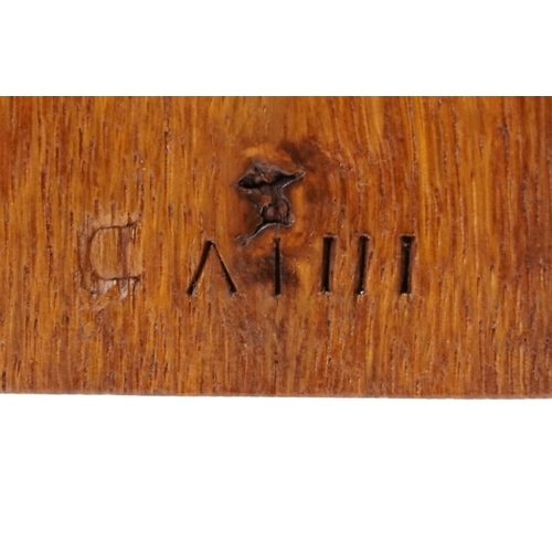 1197 - Oak cased mantle clock having silvered dial with Arabic numerals, striking on a gong, 34.5cm high