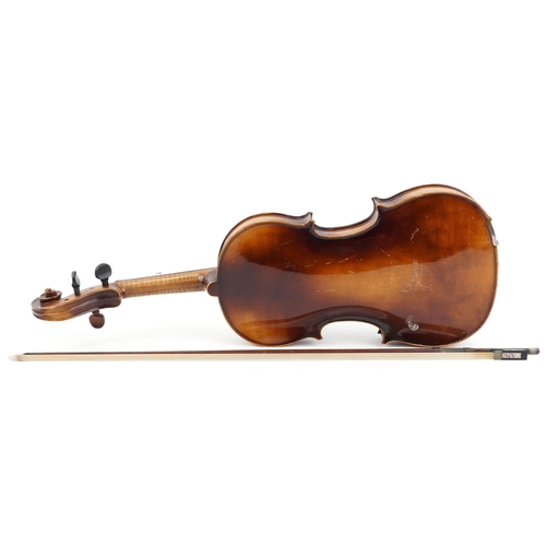 1433 - Old wooden violin and bow bearing a Stradivarius paper label to the interior, the violin back 16 1/4... 