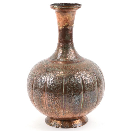 1326 - Middle Eastern copper vase profusely engraved with foliage, 32cm high