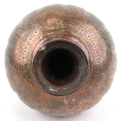 1326 - Middle Eastern copper vase profusely engraved with foliage, 32cm high