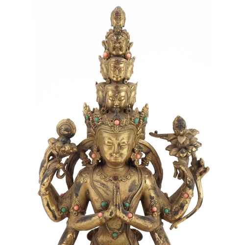 1155 - Tibetan bronze Buddha seated in the lotus position set with turquoise and coral coloured cabochons, ... 