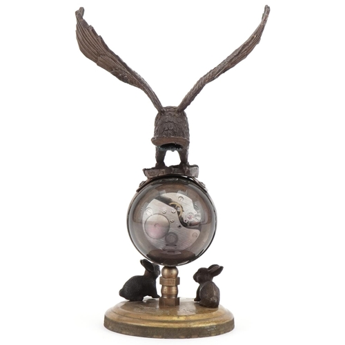 2205 - Bronzed and glass globular desk clock mounted with an eagle, 21cm high