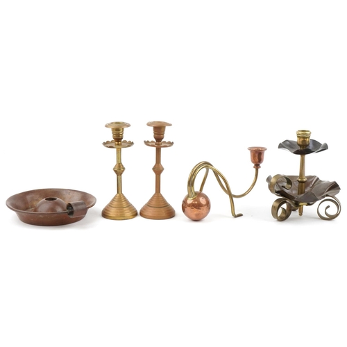 26 - Christopher Dresser Arts & Crafts copper and brass candlesticks and a brass chamberstick, the larges... 