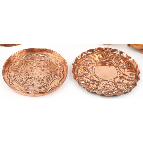 175 - Arts & Crafts copperware including floral and fish design trays, pots etc, the largest 25cm in diame... 