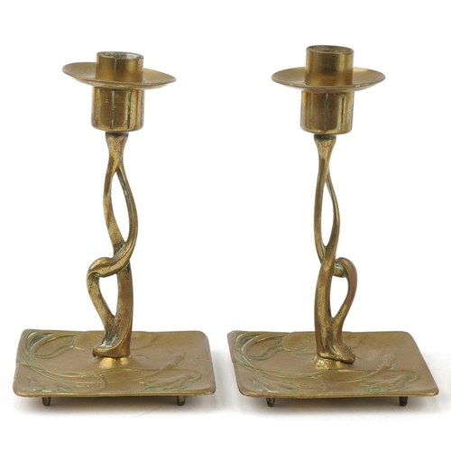 27 - Arts & Crafts brass and copper candlesticks including a W.A.S Benson example, the largest 20cm high