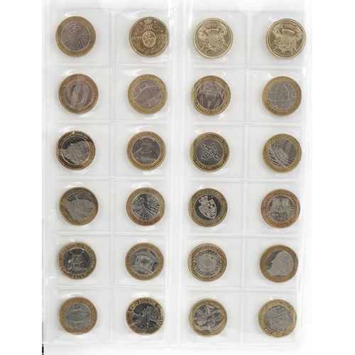 2447 - Coin album containing sixty six two pound coins and thirty pounds in fifty pence pieces, all legal t... 