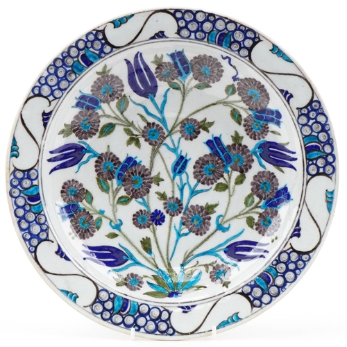 1286 - Turkish Ottoman Iznik plate hand painted with stylized flowers and foliage, 33cm in diameter