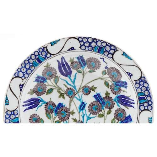 1286 - Turkish Ottoman Iznik plate hand painted with stylized flowers and foliage, 33cm in diameter