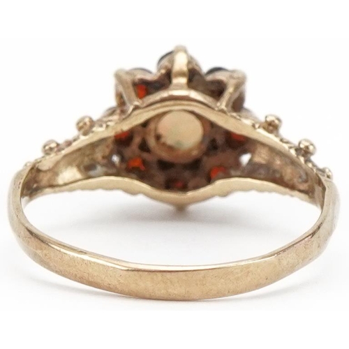 3313 - 9ct gold opal and garnet flower head ring with naturalistic setting, size K, 1.8g