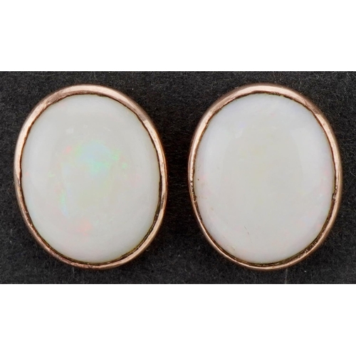 3395 - Pair of unmarked gold cabochon opal earrings with screw backs, each approximately 1.4cm x 1.1cm, tot... 