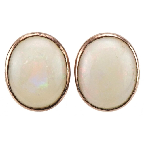 3395 - Pair of unmarked gold cabochon opal earrings with screw backs, each approximately 1.4cm x 1.1cm, tot... 