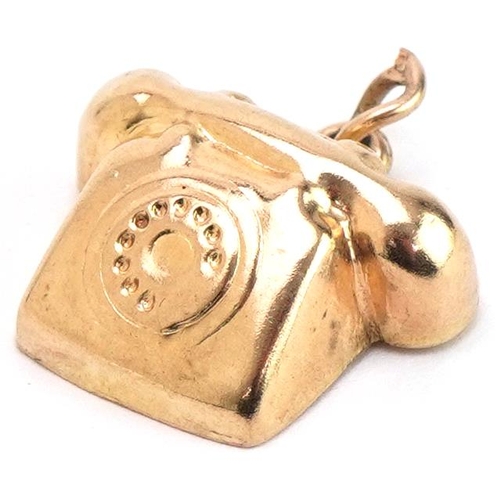 3443 - 9ct gold charm in the form of a vintage dial telephone, 1.7cm wide, 1.2g