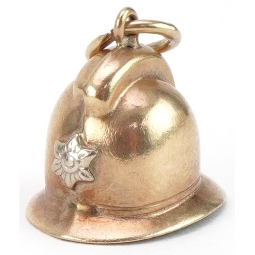 3385 - Unmarked gold charm in the form of a policeman's helmet, 1.3cm high, 1.1g