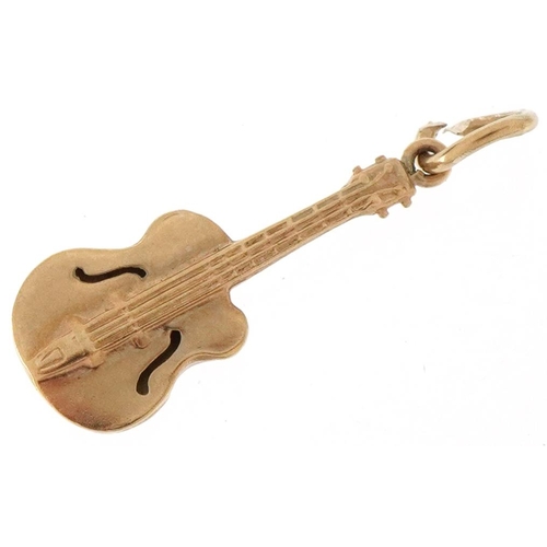 3360 - 9ct gold charm in the form of a guitar, 2.1cm high, 0.6g