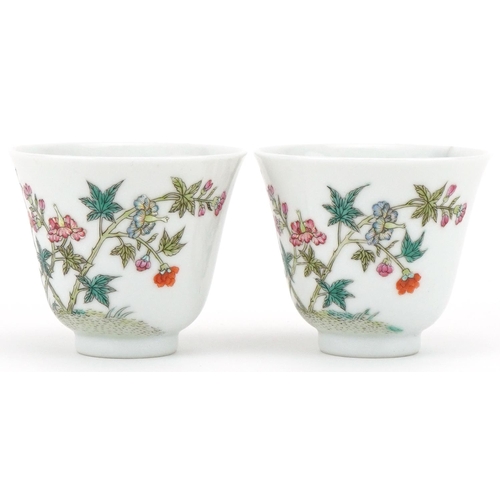 1017 - Pair of Chinese porcelain tea bowls hand painted with flowers, six figure character mark to the base... 