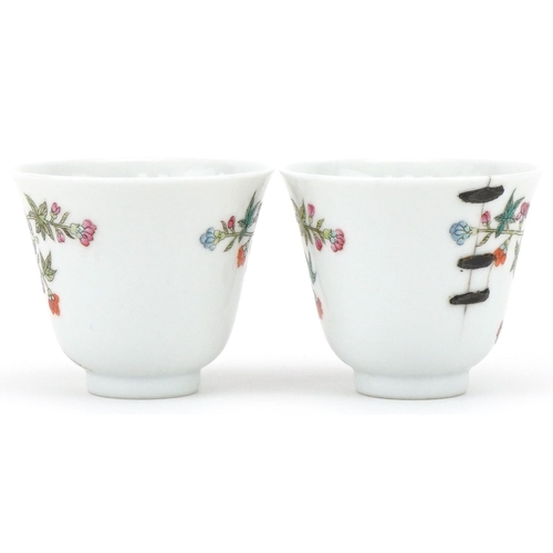 1017 - Pair of Chinese porcelain tea bowls hand painted with flowers, six figure character mark to the base... 